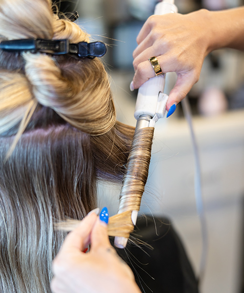 Sandy blond haired girl, getting her hair curled